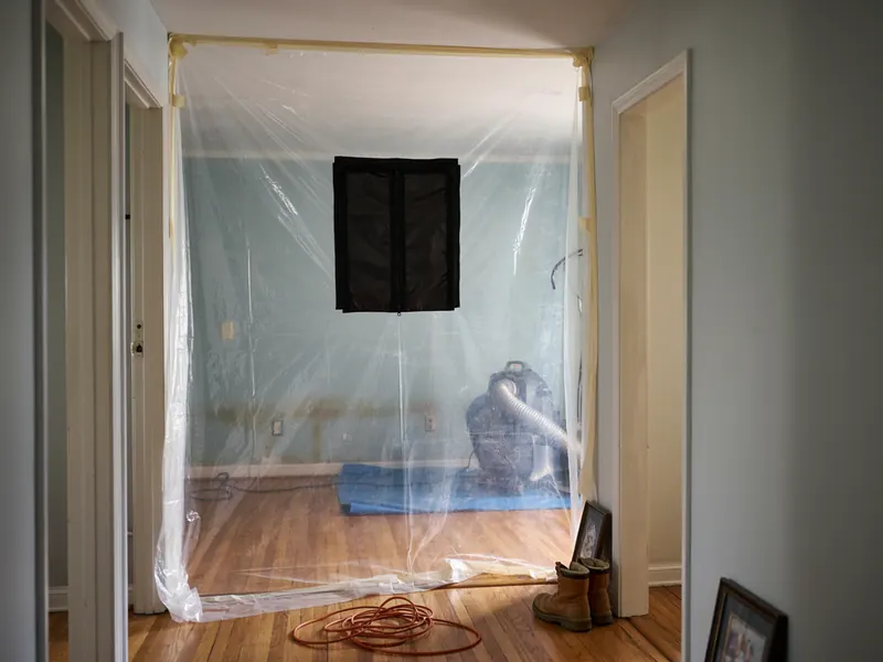 Room sealed off with plastic containment sheeting during mold removal